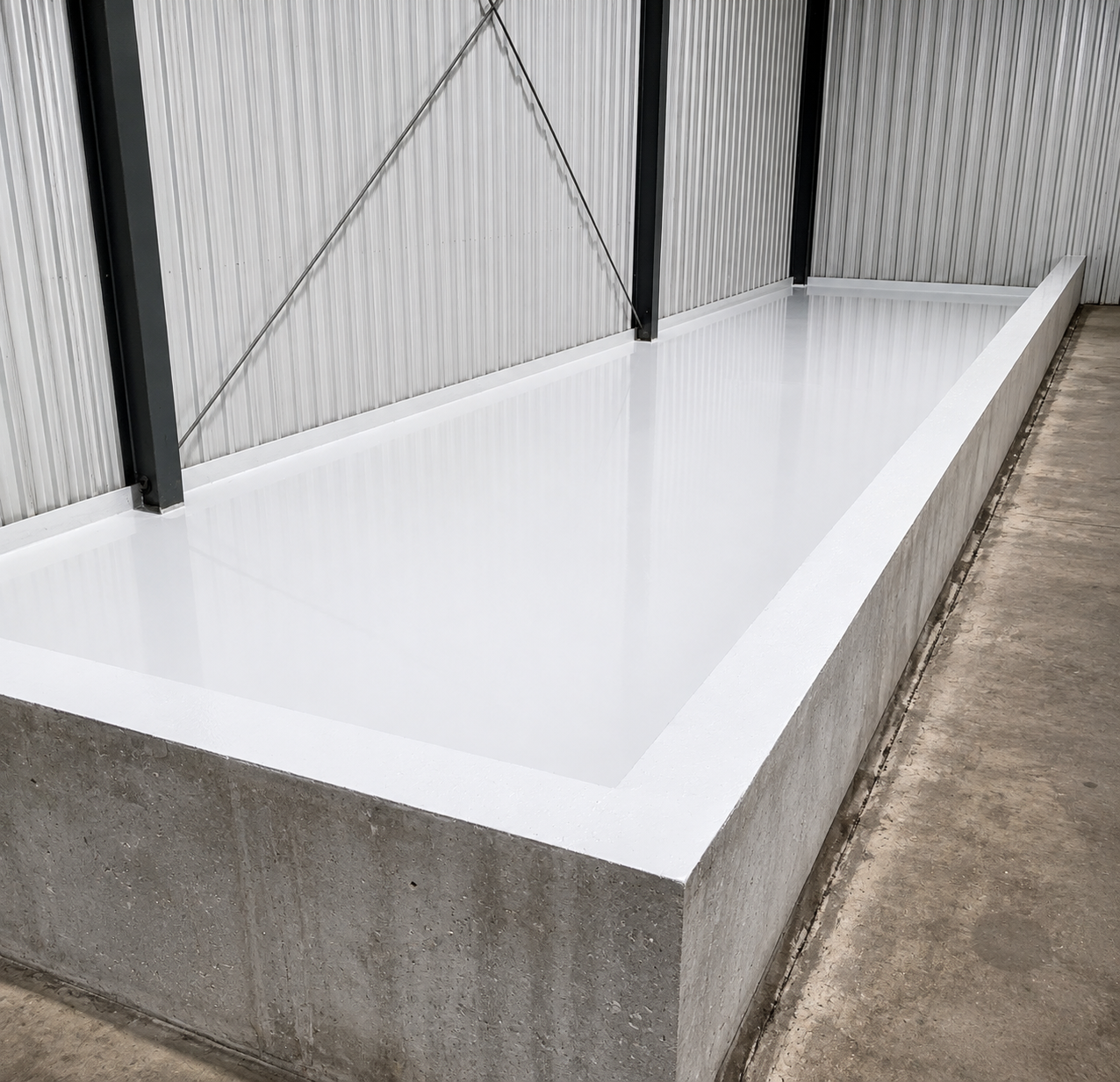 White epoxy coated commercial equipment pit after coating
