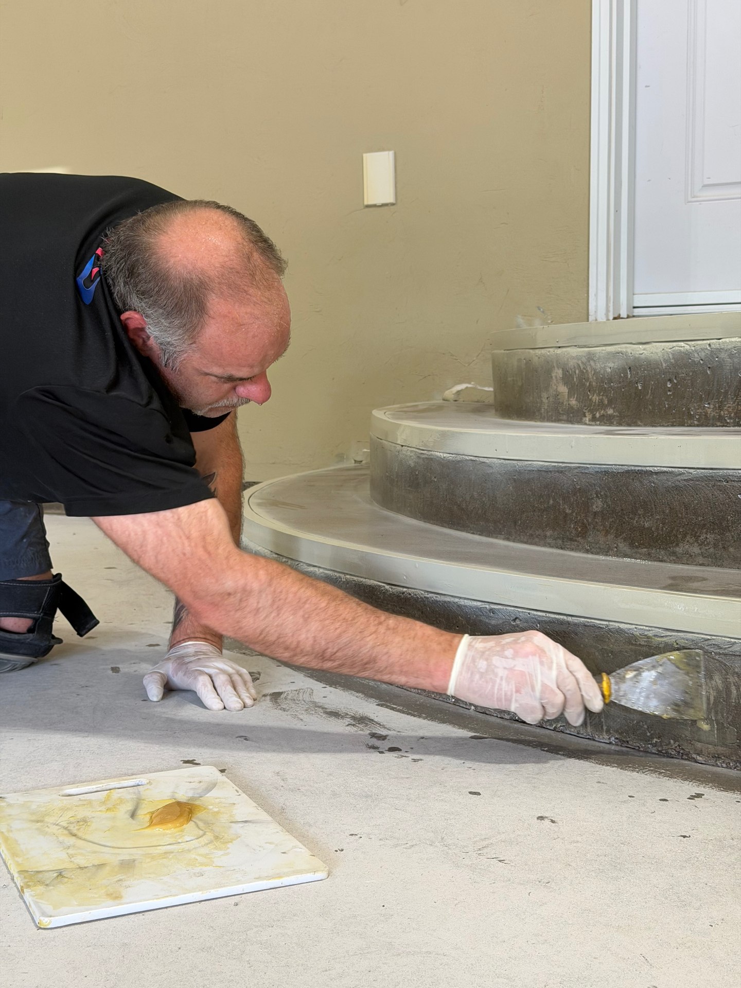 Rick Melanson, Owner of Modern Epoxy, applying epoxy to a concrete step